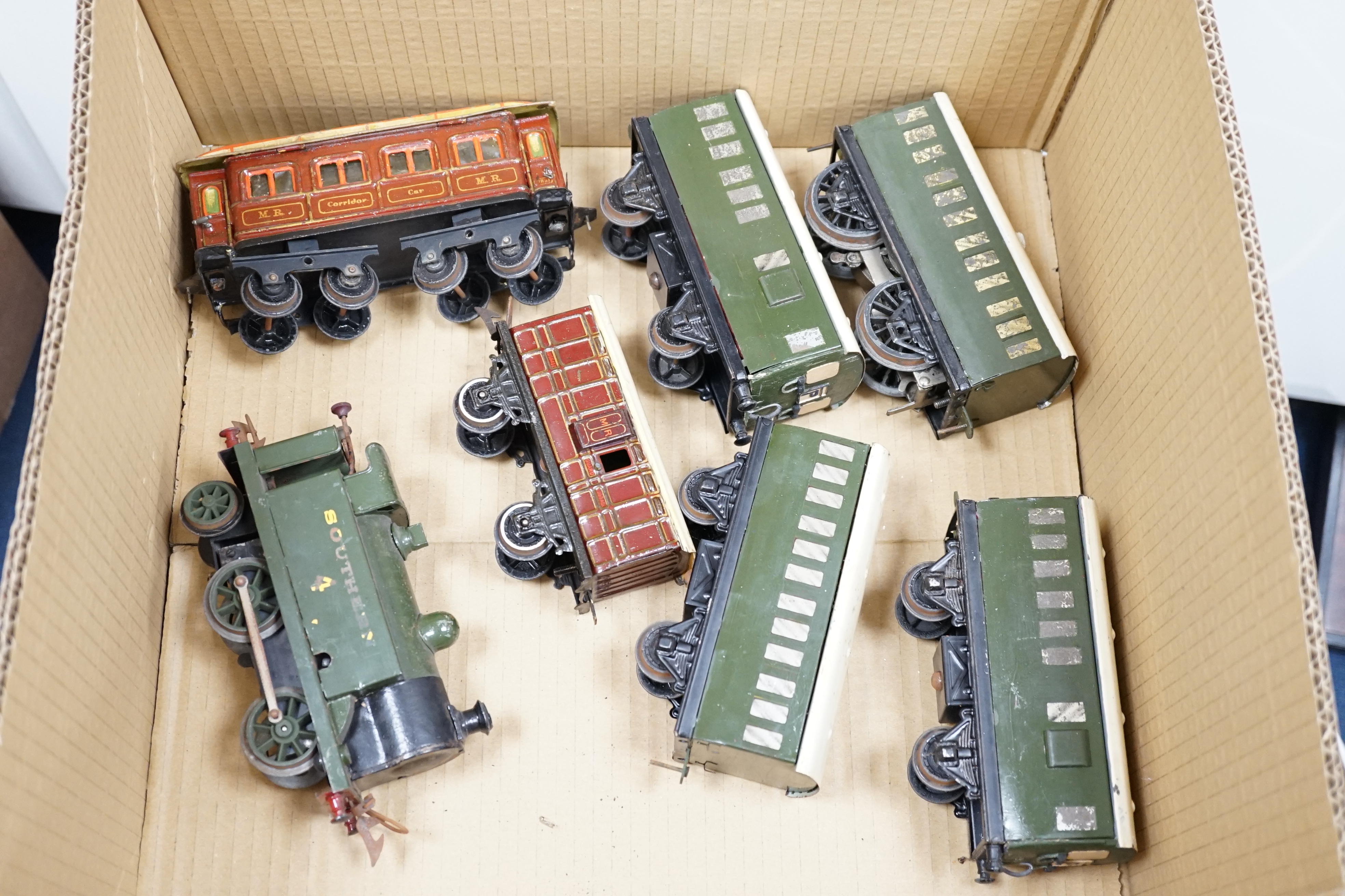 Ten 0 gauge tinplate railway items, most adapted from other parts and models, including three clockwork locomotives; n LSWR 4-4-0 tender loco, an LMS 0-4-4T loco and an SR 0-4-2T loco, together with four SR 4-wheel coach